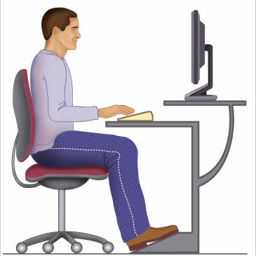Man sitting with good posture at a desk.