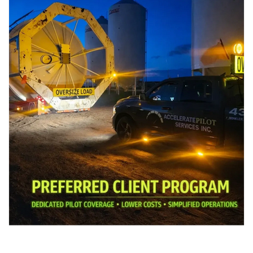Accelerate Pilot Services pilot truck escorting an oversize load at night in Western Canada, represe