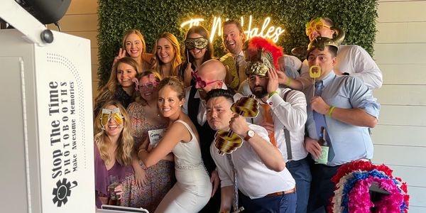 Guests enjoying glam photo booth at wedding