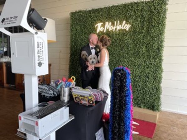 Bride and groom enjoying wedding photo booth