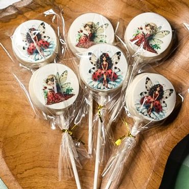 Lollipops with fairy illustrations wrapped in clear plastic.