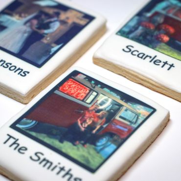 Personalized photo cookies showcasing family names and pictures.