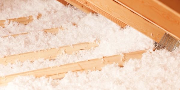 Spray foam insulation being applied in an attic.