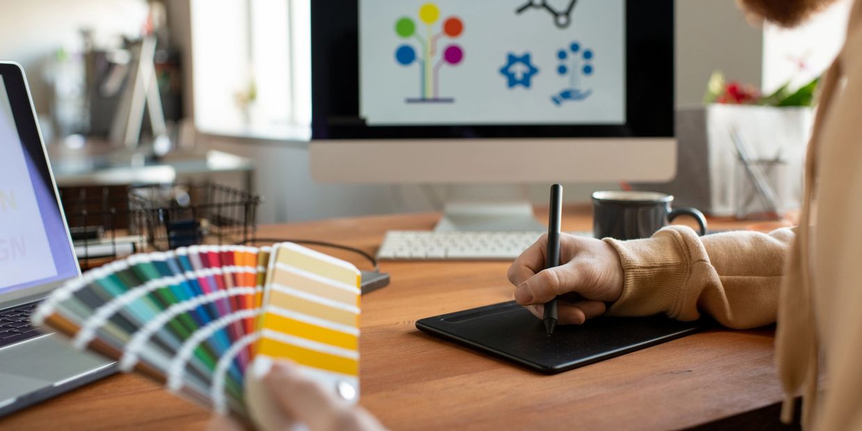 Graphic designer working with color swatches and a digital tablet.