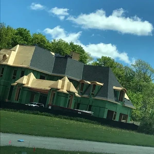 Picture of custom home roof installation in progress.