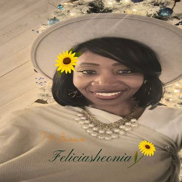 Smiling woman wearing a large hat and pearl necklace with floral decorations and text overlay.