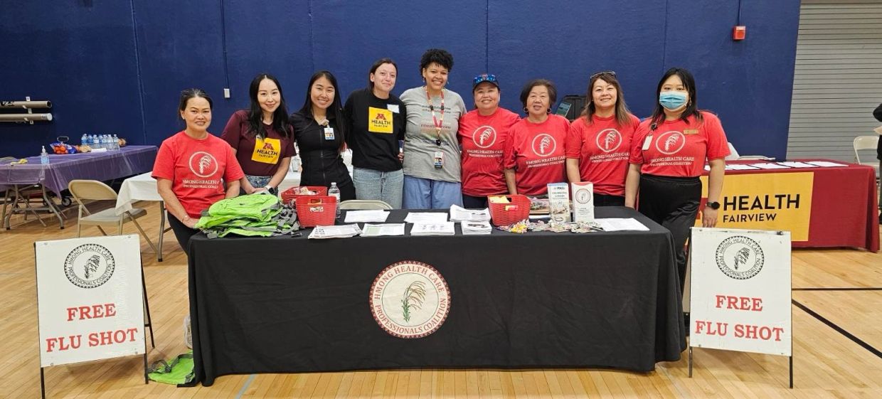 Group promoting free flu shots at a health event.