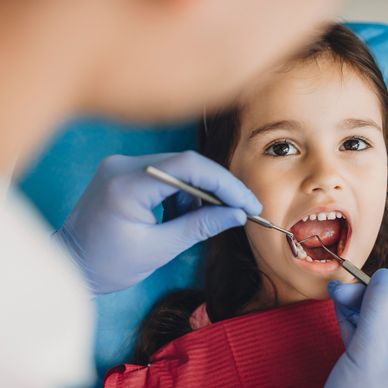 A child receives a gentle dental exam, part of specialized cavity treatment for kids.