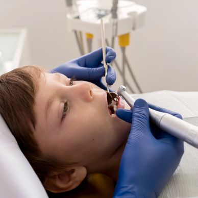 A child receives gentle root canal treatment for kids from a pediatric dentist.