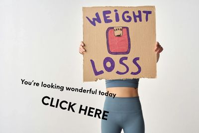 girl holding a weight loss sign