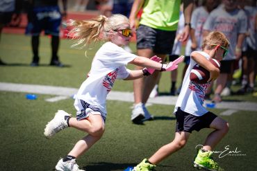 Children playing an outdoor game on a sunny day.