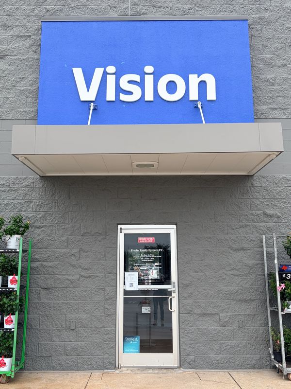 Storefront with the word Vision on a blue sign.