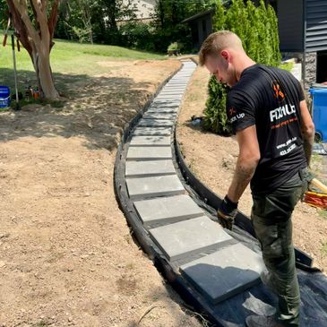 Zach Fowler - Owner of FiXit Up Home & Property Services, LLC. Installing walkway pavers. 