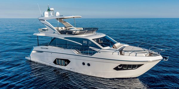 White luxury yacht sailing on calm ocean.