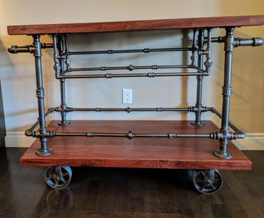 MASSIVE 2-in THICK AFRICAN MAHOGANY BAR CART WITH 2-in CAST IRON WHEELS AND IRON PIPE WORKINGS