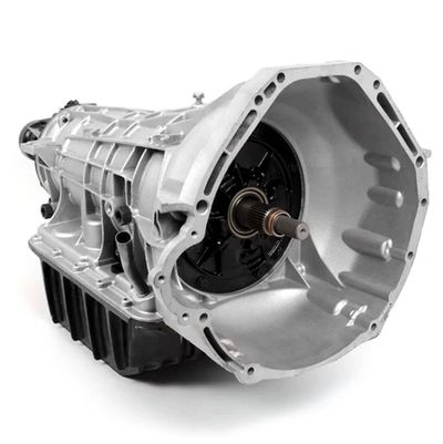 Silver automotive transmission gearbox on white background.