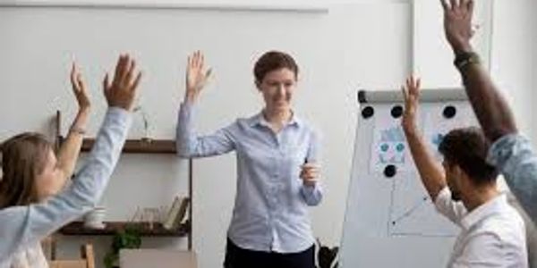 Team meeting with raised hands.