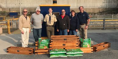 Troop 82 Eagle Scout candidate Aaron Valint presents window boxes.