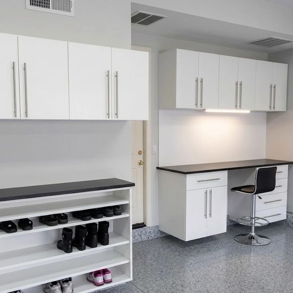 Modern, clean white cabinets and shelves in a spacious, organized room with polished floors.