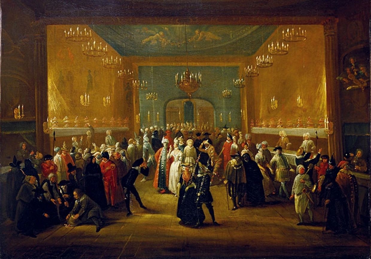 A large group of people in historical costumes indoors with chandeliers.