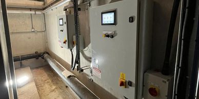 Custom electrical pump control panel installed for automated system management.