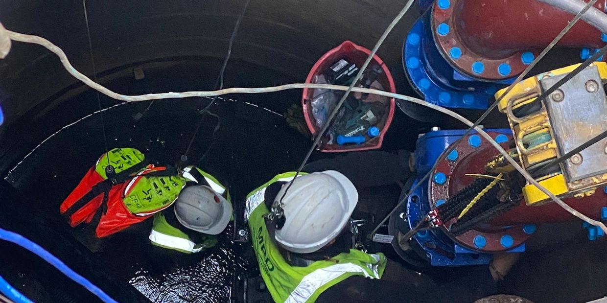 MPD Pumps engineers working inside a subterranean wet well chamber at the ICC Birmingham.
