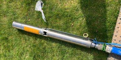 Stainless steel submersible borehole pump for underground water extraction.
