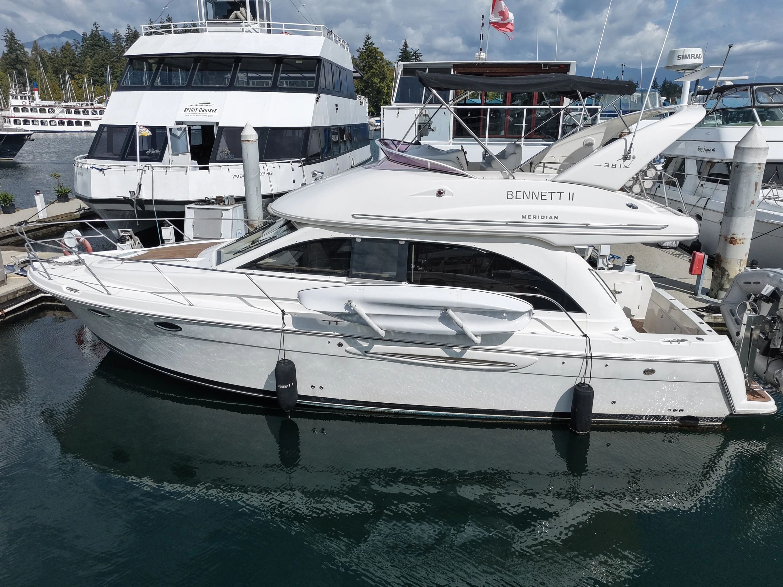 White boat named Bennett II docked at marina.