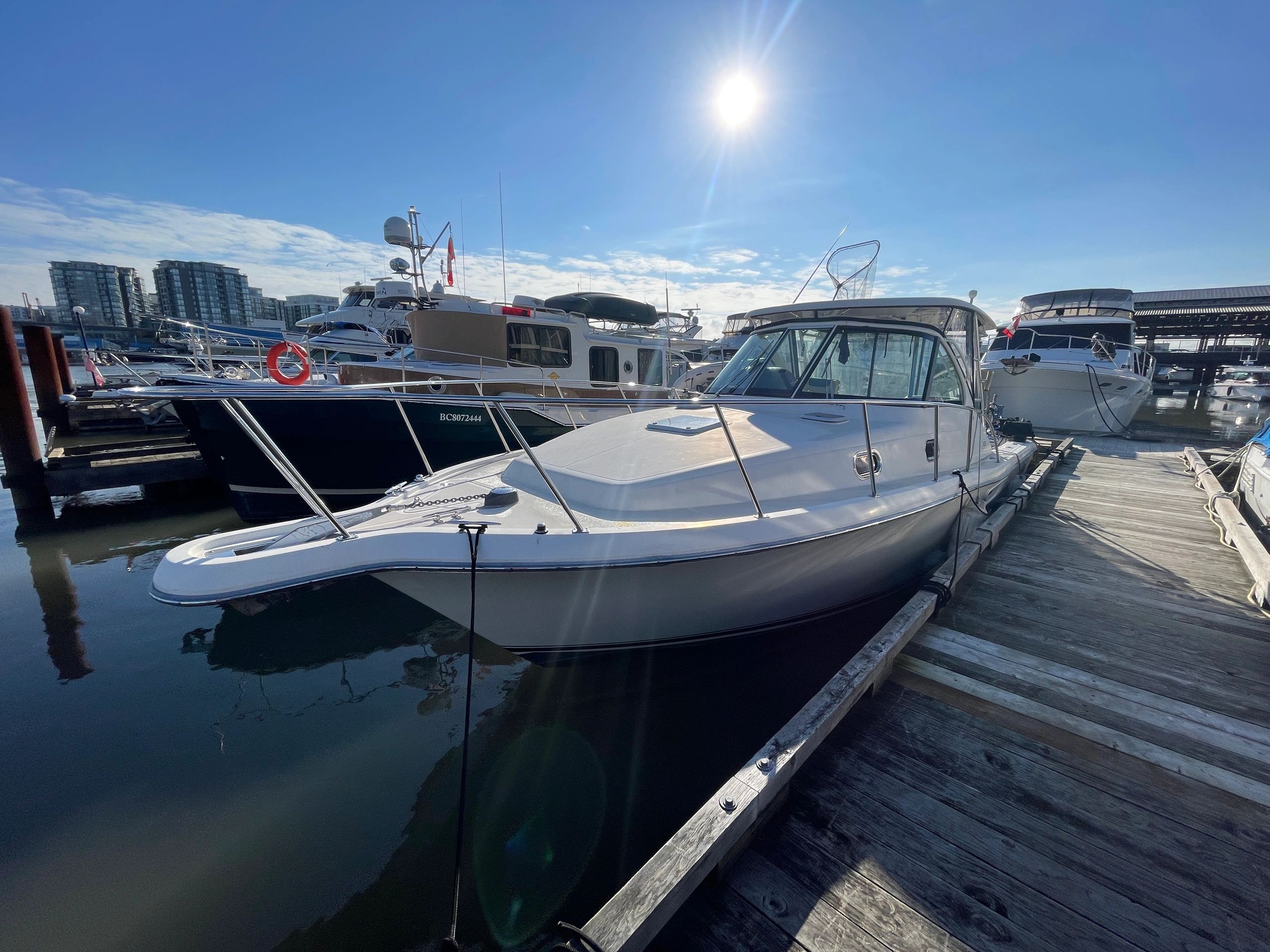 Boats docked at a marina on a sunny day.