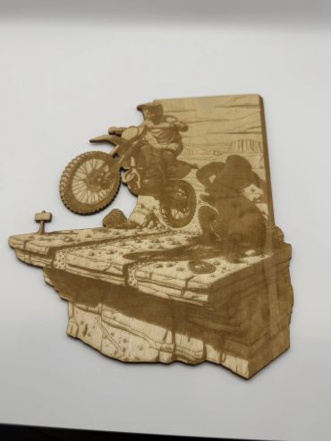 Wooden art depicting a motocross jump.