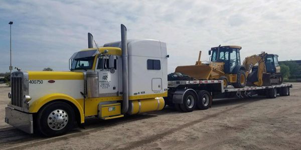 Hauling equipment on a step deck trailer