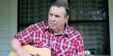 closeup shot of a man playing guitar 