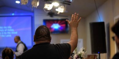 Man raising his hand during a church service.