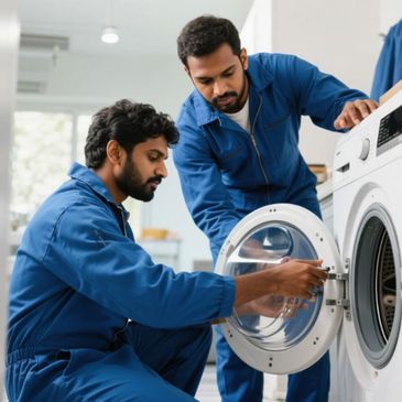 Two technicians in blue coveralls inspecting a washing machine door.