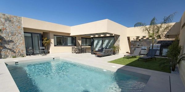 Modern backyard with pool and lounge area.