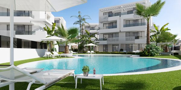 Contemporary apartment complex with curved pool and palm trees.