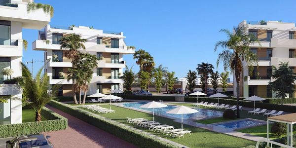 Modern residential complex with swimming pool and palm trees.