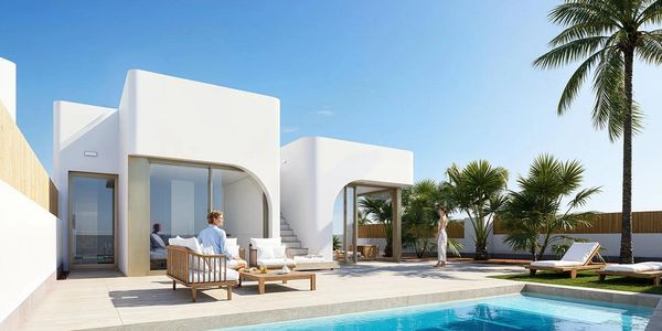 Modern white villa with pool and palm trees under clear blue sky.