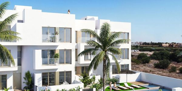 Modern white villa with pool and palm trees.