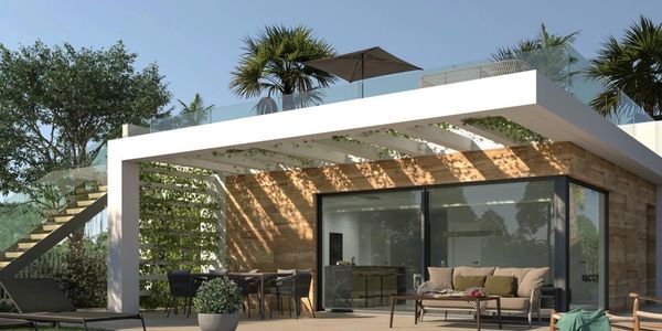 Modern outdoor patio with greenery and seating.