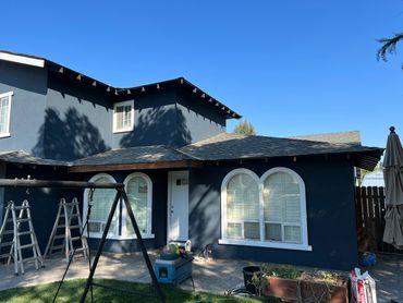 Black colored independent house with a swing