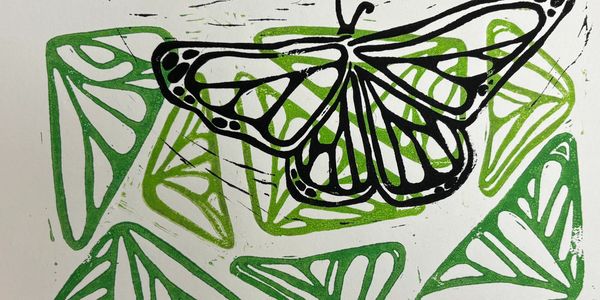 Black butterfly printed on green organic shapes