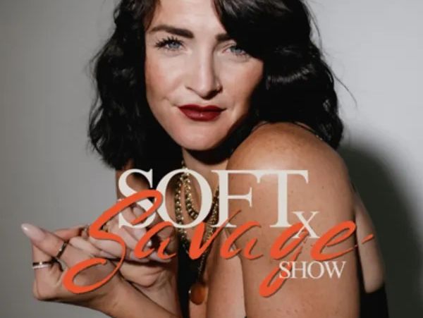 Confident woman with dark hair posing for the Soft x Savage Show.