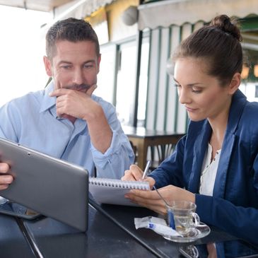 A man and a woman looking at the tablet