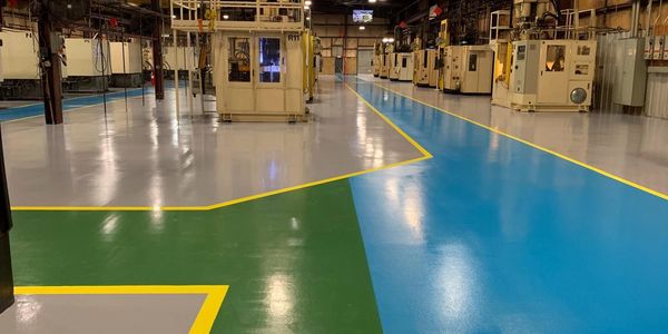 Traffic lines and epoxy floor coatings for industrial manufacturing facilities