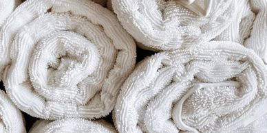 Rolled white towels neatly arranged.