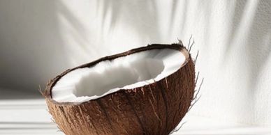 A half coconut with white flesh inside.