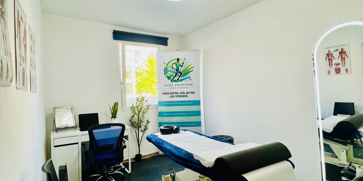 A bright massage room with a treatment table, natural light, and calming decor, designed for relaxat