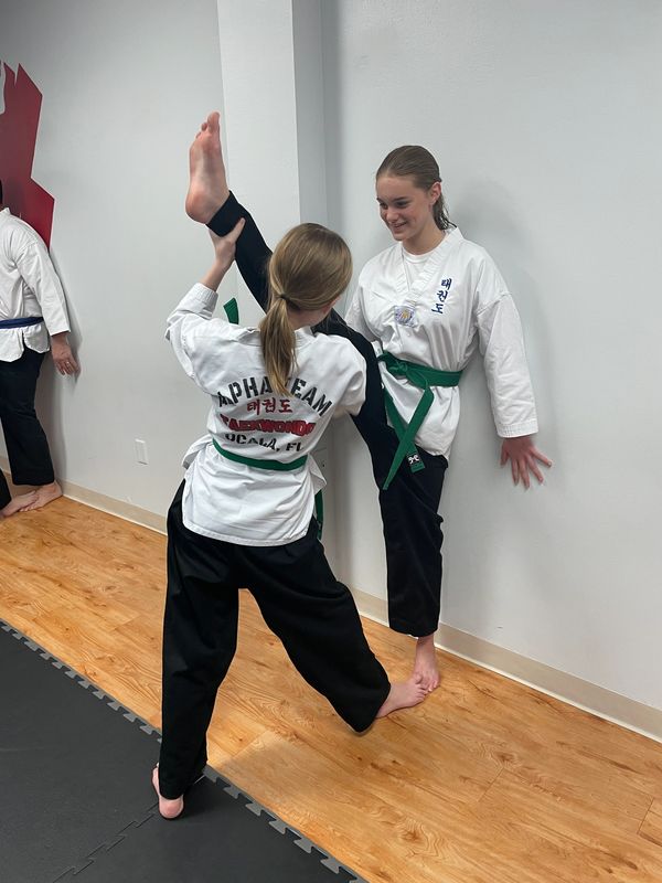 Two girls from Alpha Team showing their martial arts moves.