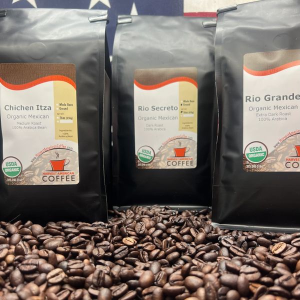 Three bags of organic Mexican coffee with coffee beans in front.
